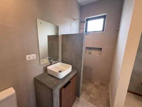 a bathroom with a sink and a mirror at Casa Palmyre in Rivière Noire