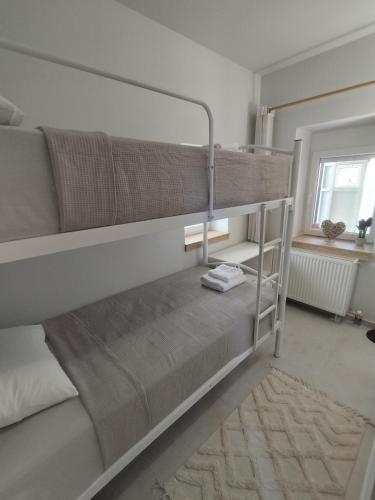 a bunk bed in a room with a mirror at KIS Home in Loúros