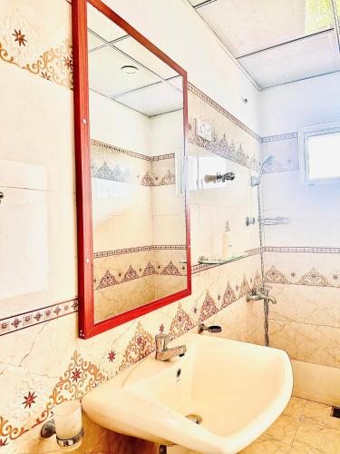 a bathroom with a sink and a mirror at Ella Nature Life Guest & Restaurant -Free Pickup from Ella in Ella