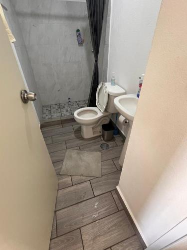 a bathroom with a toilet and a sink at La Casa de Coco in Tlayacapan