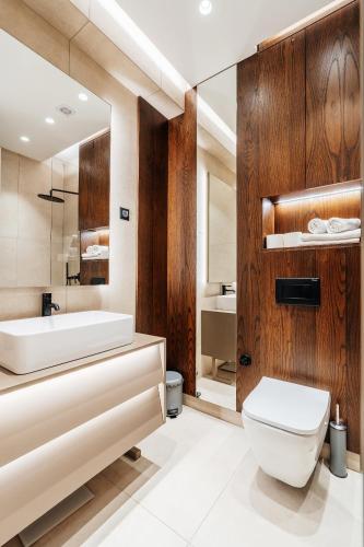 a bathroom with a sink and a toilet and a tub at Coastal Residences by In Property in Bečići