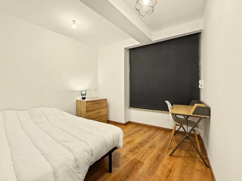 a bedroom with a bed and a blackboard on the wall at Le Vercors in Valence