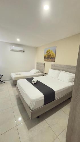 a bedroom with two beds in a room at Nacar Boutique hotel in Valledupar