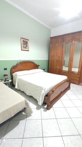 a bedroom with two beds and a mirror at Casa Cesa in Selargius