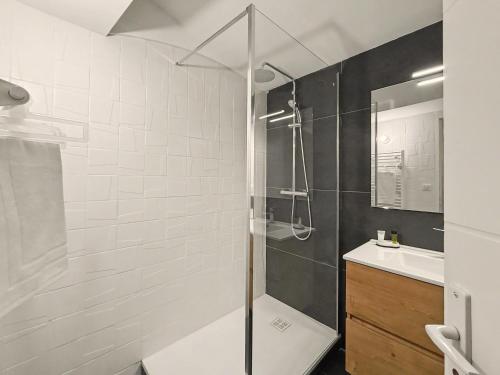 a bathroom with a shower and a sink at Sous Les Toits in Valence