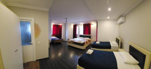 a hotel room with two beds and a hallway at JULI Veal in Tepelenë