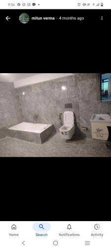 a bathroom with a tub and a toilet and a sink at Hotel shree ji in Lucknow