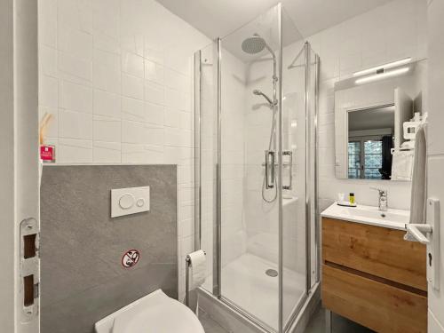 a bathroom with a shower and a toilet and a sink at Le Refuge in Valence