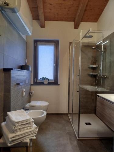 a bathroom with a shower and a toilet and a sink at Il Giardino di Sofia B&B in Piozzo
