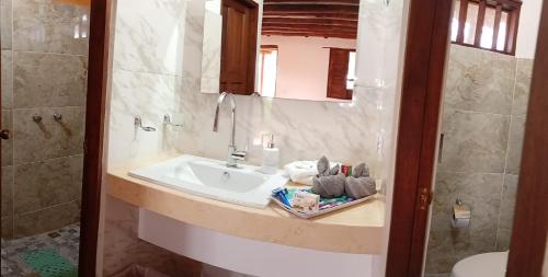 a bathroom with a sink and a toilet at HotelQuintaMaria in Barichara