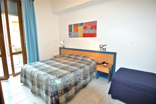 Postel nebo postele na pokoji v ubytování Albergo Rossella