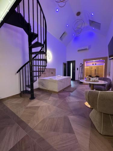 a living room with a staircase and a couch at Spa Signature in Dijon