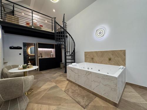 a large bathroom with a tub and a staircase at Spa Signature in Dijon