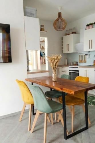 a kitchen with a wooden table and chairs at Apartament na Bora in Tarnów