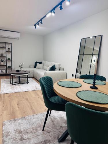 a living room with a table and a couch at martIN Apartment 2 in Bansko