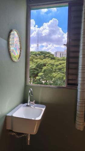 a bathroom with a sink and a window at Hotel Real Paulista in São Paulo