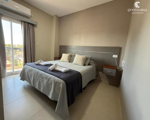 a bedroom with a bed with two towels on it at ALOJAMIENTO CENTENARIO in Corrientes