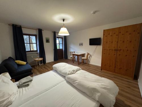 a bedroom with a bed and a living room at Bergauszeit mit Sauna in Aschau im Chiemgau