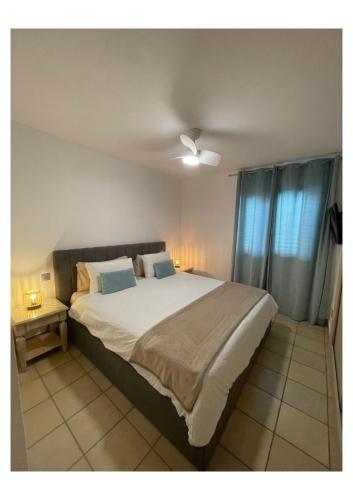 a bedroom with a large bed with a ceiling fan at Apartamento Kai in Playa Jandia
