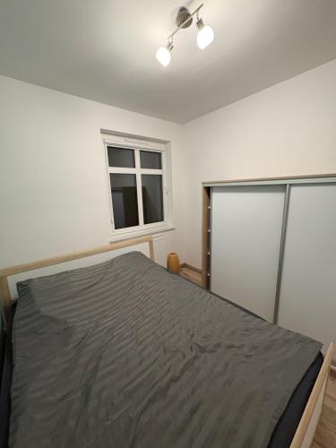 a bedroom with a bed and a window at Panda Apartment Plac Solny 4 z klimatyzacją in Głogów