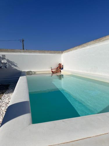 a woman sitting on the floor of a swimming pool at Wine under the Stars in Reguengos de Monsaraz