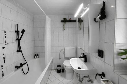 a bathroom with a toilet and a sink and a shower at The Günz Homes 1 in Günzburg