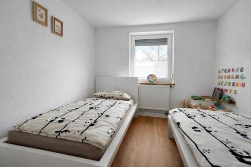 a bedroom with two beds and a window at The Günz Homes 1 in Günzburg