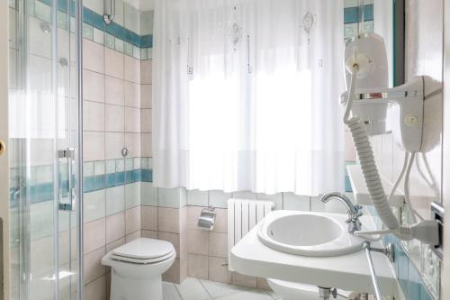 a bathroom with a toilet and a sink and a shower at Affittacamere Prima Fila Mare in Porto Recanati