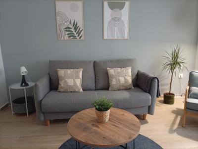a living room with a couch and a table at Apartamentos La Machacona Plaza Mayor recién reformados in Cáceres