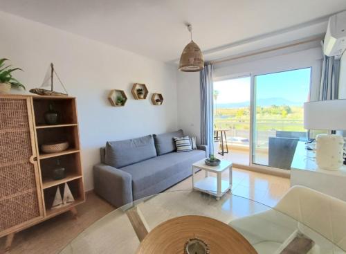 a living room with a couch and a glass table at Charli beach in Miramar