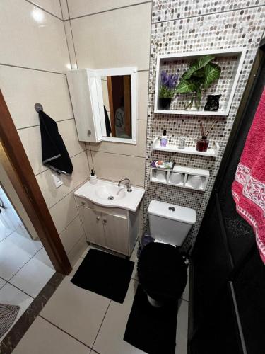 a small bathroom with a sink and a mirror at 4 min do Paraguai Casa com piscina e privacidade in Foz do Iguaçu