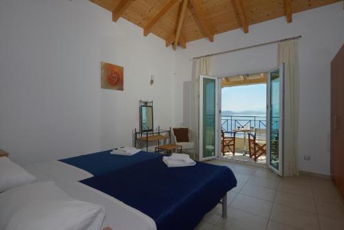 a bedroom with two beds and a view of the ocean at Eleonora Villa in Évyiros