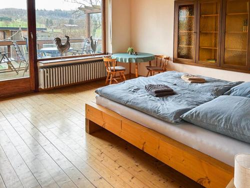 a bedroom with a bed and a table and a balcony at Hof Gottesbüren in Warburg