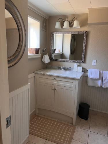 a bathroom with a sink and a mirror at Sunset Ocean Retreat in West Vancouver