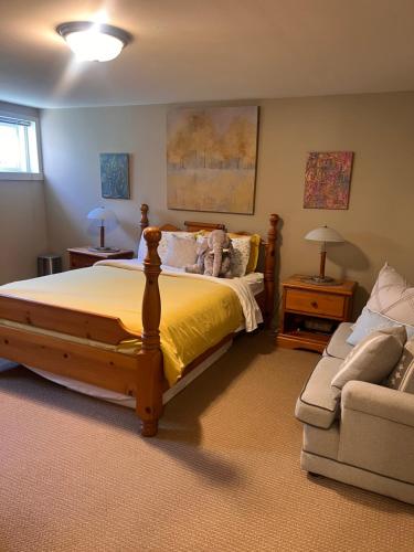 a bedroom with a large bed and a couch at Sunset Ocean Retreat in West Vancouver