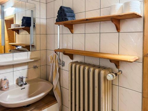 a bathroom with a radiator and a sink at Hof Gottesbüren in Warburg