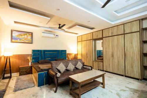 a living room with a couch and a table at Kubn Retreat in Chandigarh Airport