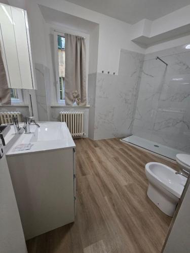 a white bathroom with a sink and a toilet at Danito Rooms 3 singola in Ancona