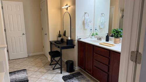 a bathroom with a sink and a mirror at Charming townhouse ideally situated in Grayson in Grayson