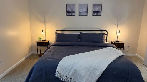 a bedroom with a blue bed with two night stands at Charming townhouse ideally situated in Grayson in Grayson