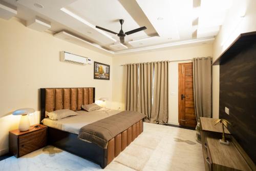 a bedroom with a bed and a flat screen tv at 2Kubn retreat in Chandigarh Airport