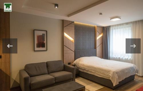 a bedroom with a bed and a couch and a chair at Maksim 2 in Iglići