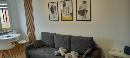 a living room with a couch with a stuffed animal on it at Apartament 7 Piętro in Wałbrzych