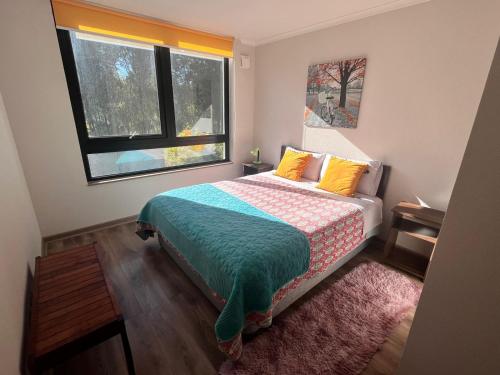 a bedroom with a bed and a window at laguna verde apart in Los Ángeles