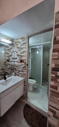a bathroom with a tub and a toilet and a sink at Panoramic House - Midelt Family Triplexe in Midelt