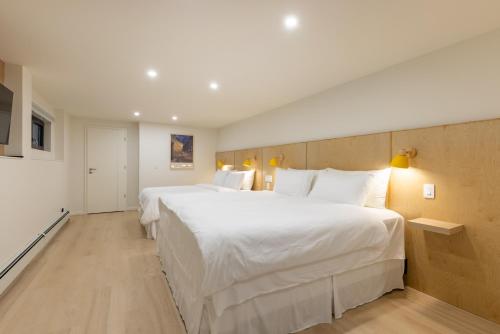 a large white bed in a hotel room at Modern King-Size Guest Suite with AC in Burnaby