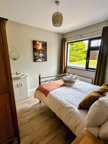 a bedroom with a bed and a large window at Whitepark Lodge in Lisnaskea