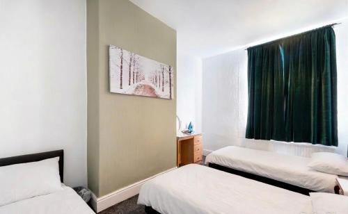 a room with two beds and a window at Rotherham Kimberworth in Kimberworth