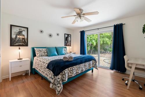 a bedroom with a bed and a ceiling fan at Boots and Barrels Ranch in Paso Robles