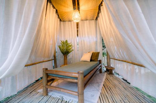 a bench sitting on a porch with a window at Alaya Panglao in Panglao Island